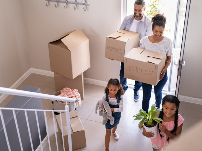 A family moving boxes into a new home
