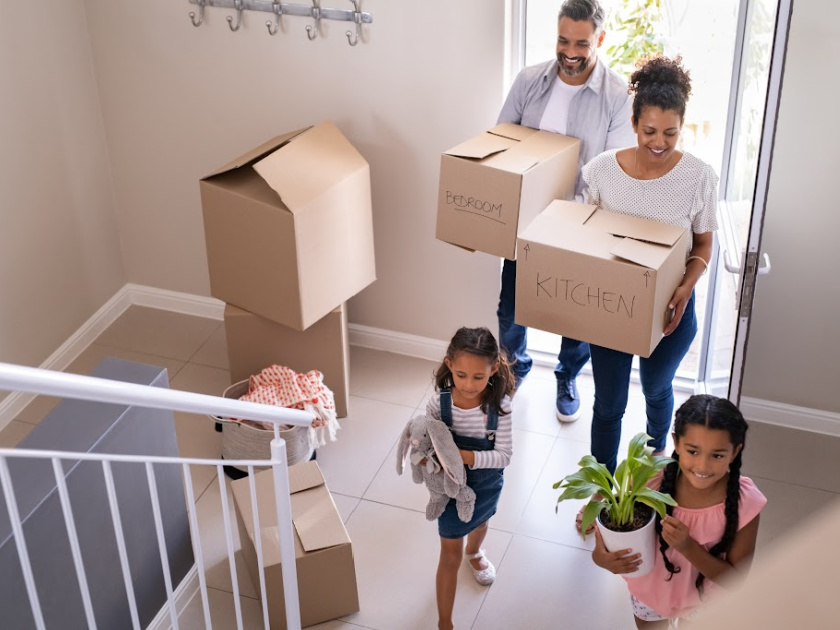 A family moving boxes into a new home